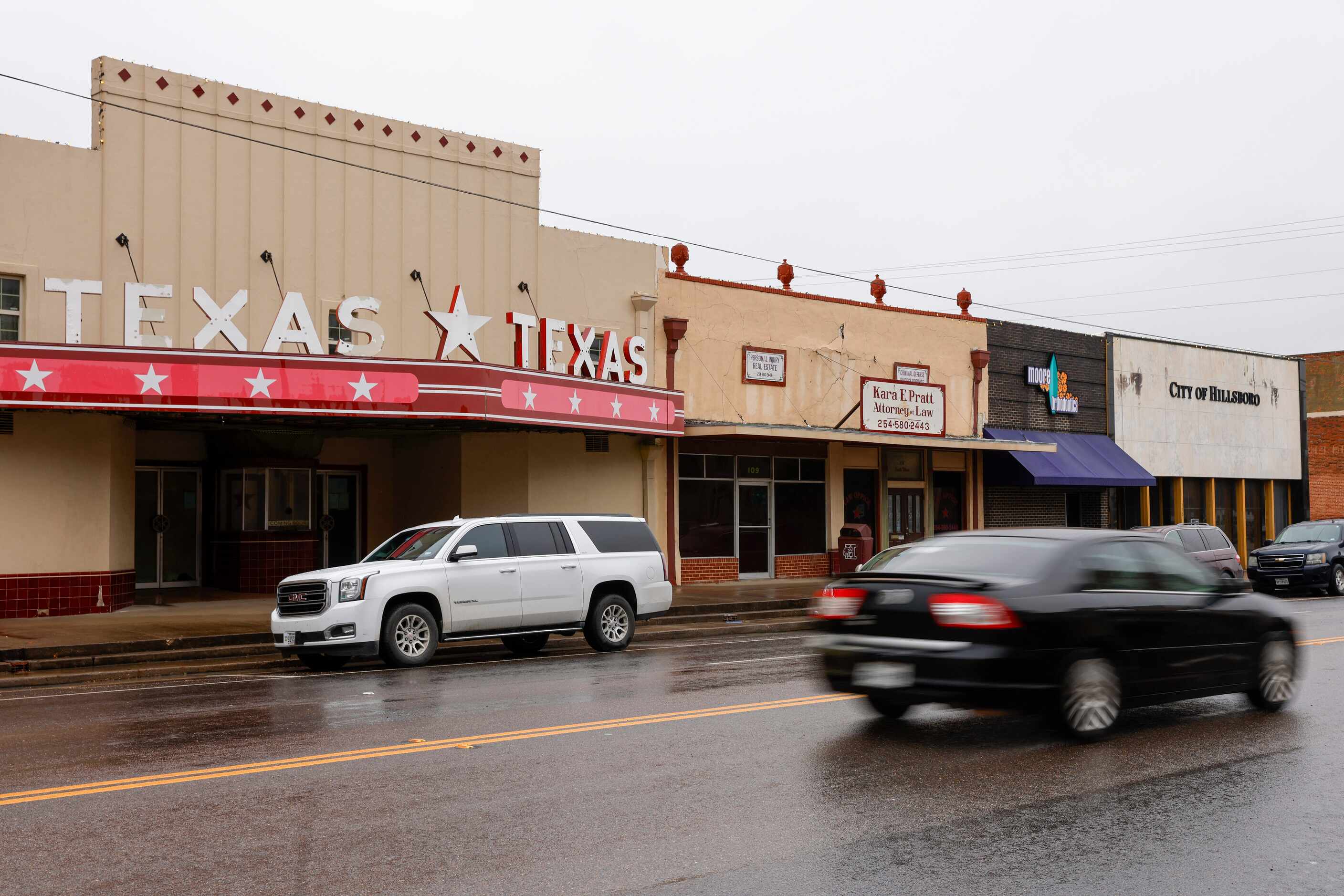 Cars drive past the Texas Arts Theatre near the square, Tuesday, Jan. 23, 2024, in...