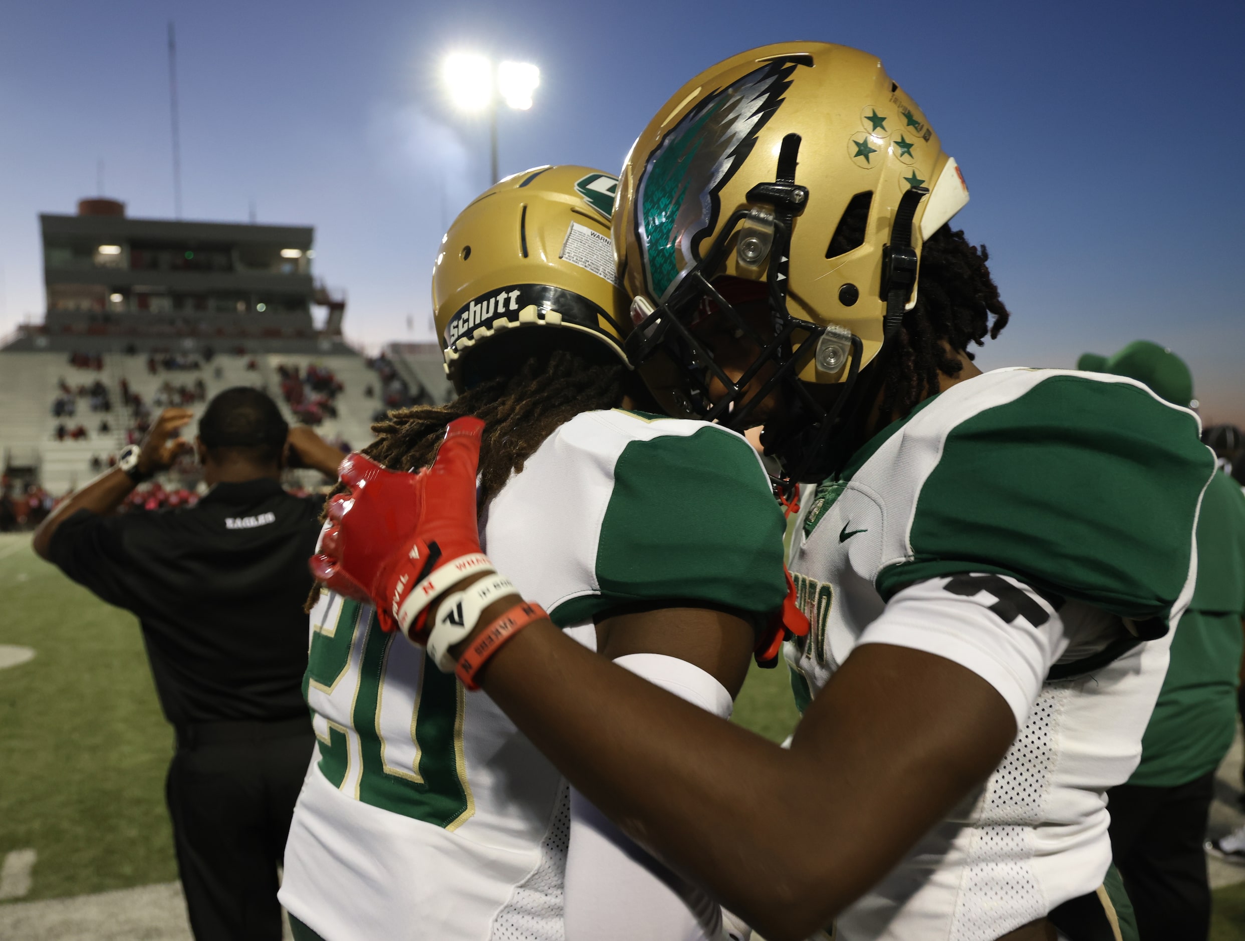 DeSoto defensive backs Akeem Rahsaan (20), left, and Mario Buford (2) share a hug before the...