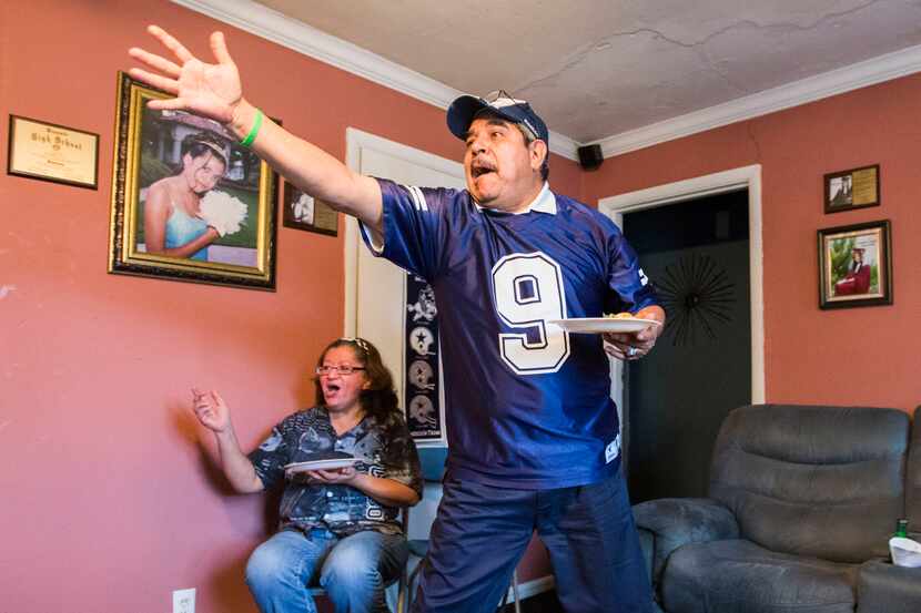 Cowboys fan Miguel Andrade, right, watches the Dallas Cowboys v. Green Bay Packers football...