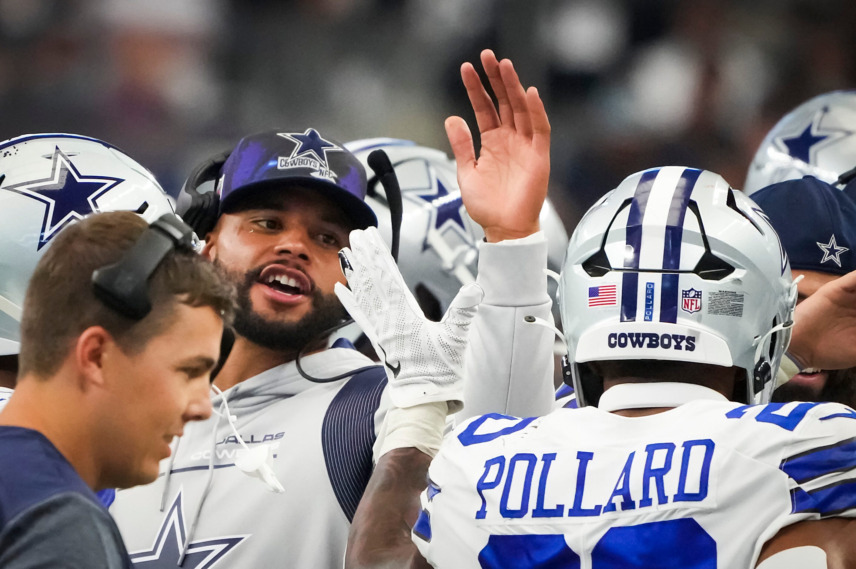 Dallas Cowboys quarterback Dak Prescott gives a hand to running back Tony Pollard (20) after...