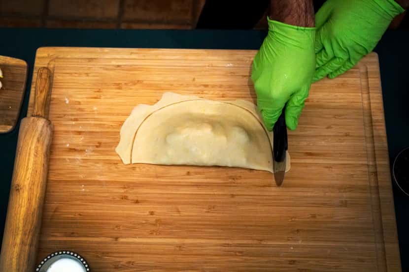 Local Chef and Hip Hop DJ Julio Cordonnier makes empanadas at his home in Euless.