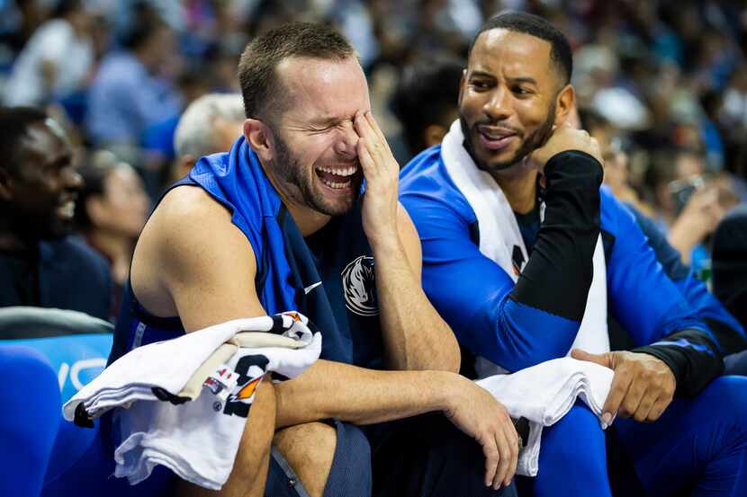 Dallas Mavericks guard J.J. Barea laught on the bench with guard Devin Harris during the...