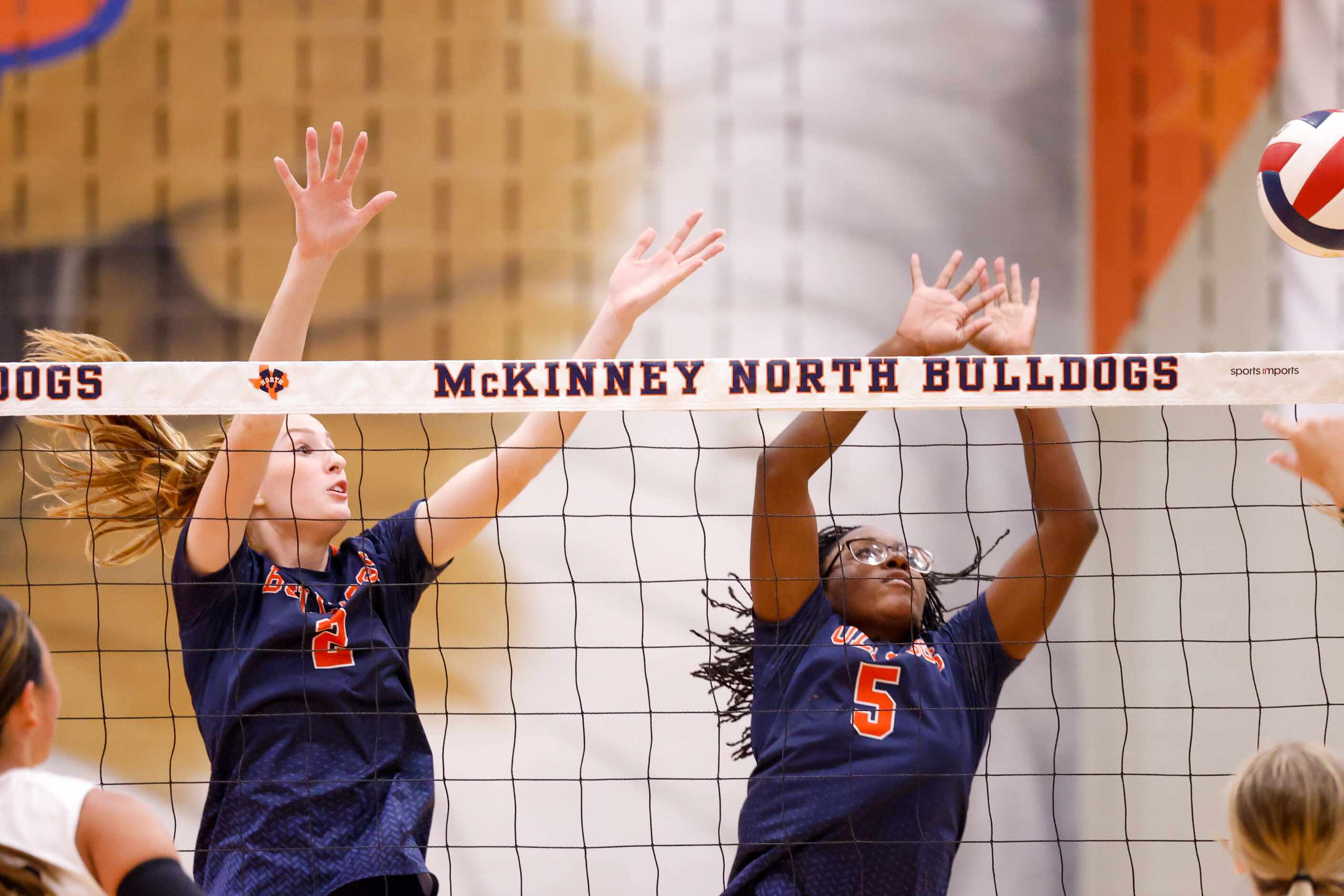 McKinney North Kayli Henderson (2) and Ayanna Moore (5) jump to block a spike by Lovejoy at...