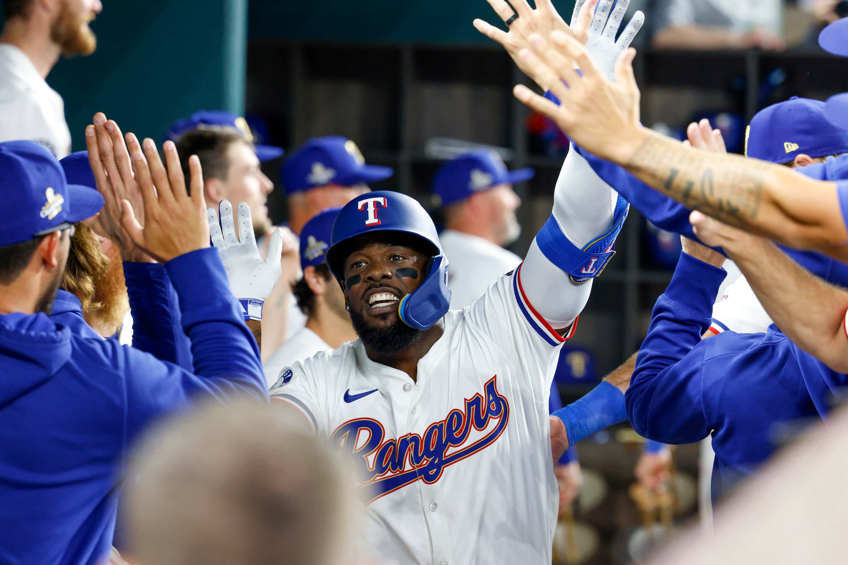 Texas Rangers right fielder Adolis Garcia (53) celebrates his home run with teammates in the...