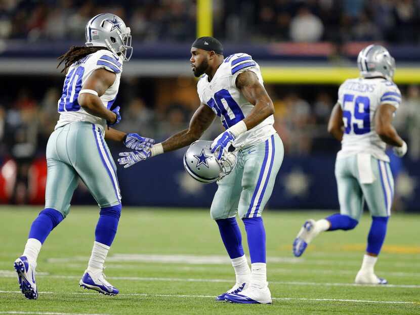 Dallas Cowboys running back Darren McFadden (20) encourages his teammates including...