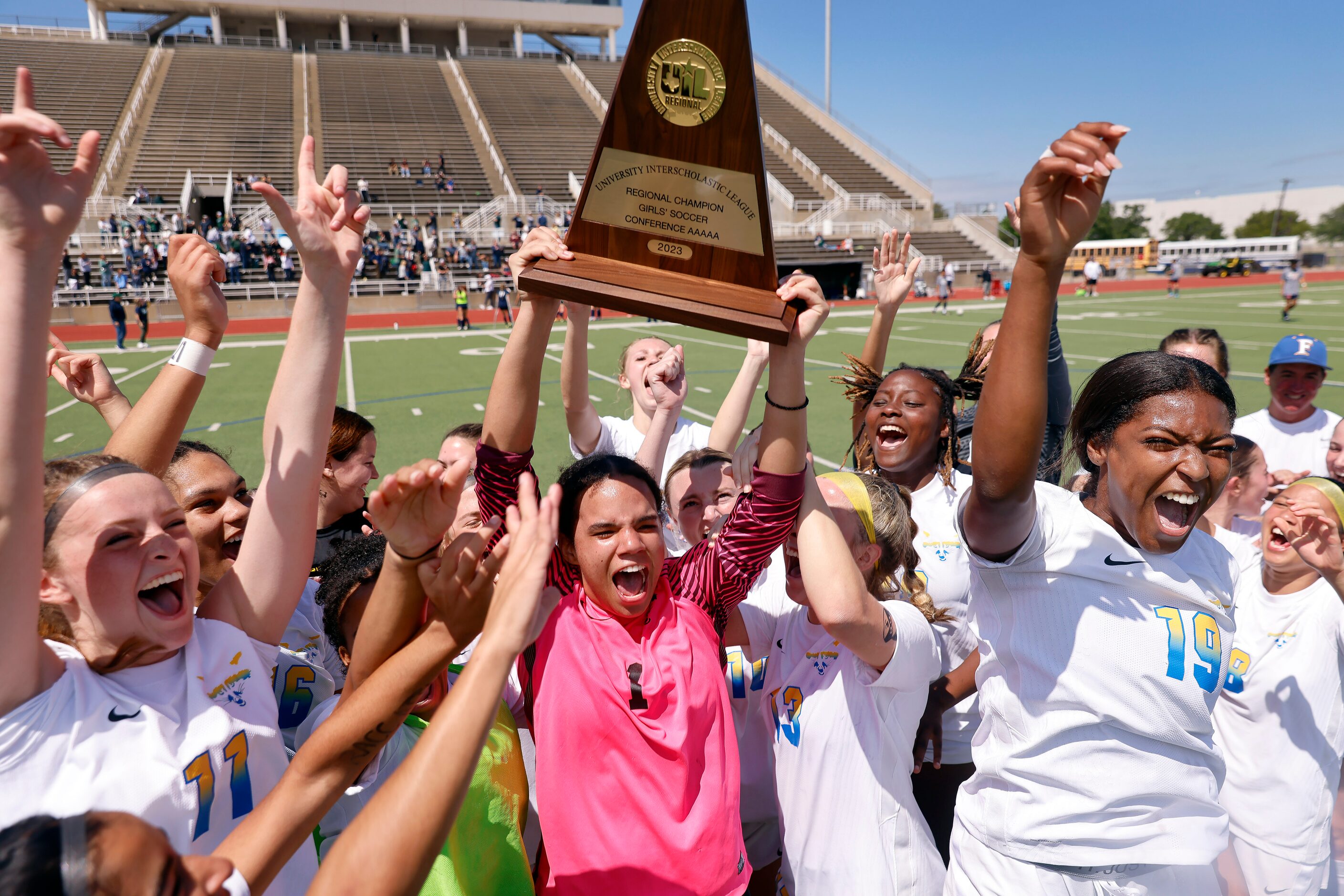 Frisco goalkeeper Ariana Anderson hoists the Class 5A Region II championship trophy after...