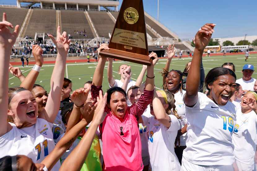 Frisco goalkeeper Ariana Anderson hoists the Class 5A Region II championship trophy after...