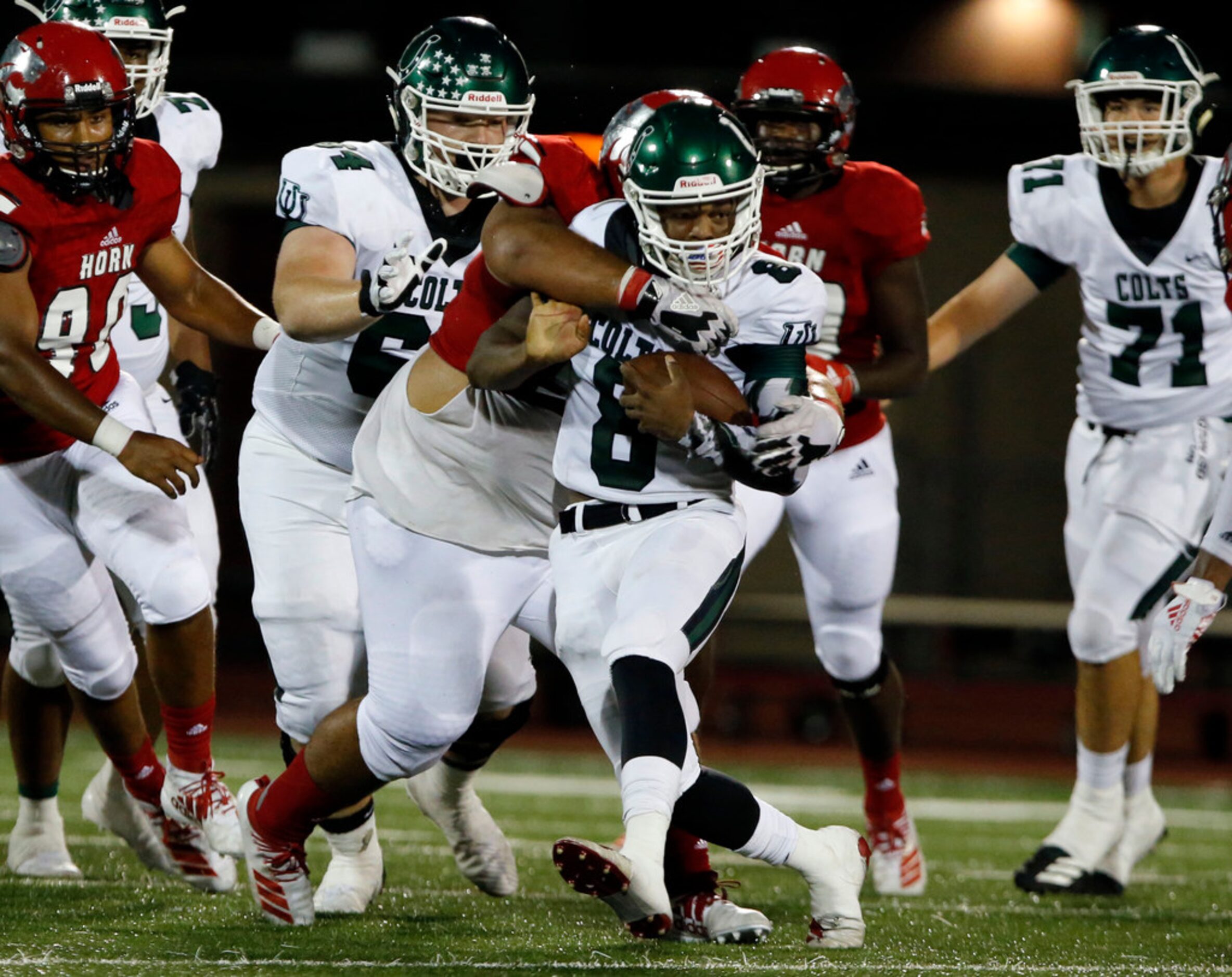 Arlington High QB Kris Sims (8) picks up a couple of hard-earned yards through the Mesquite...