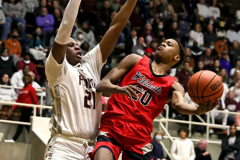 Lake Highlands guard Tre Johnson (20) tries to drive to the basket against Plano forward...