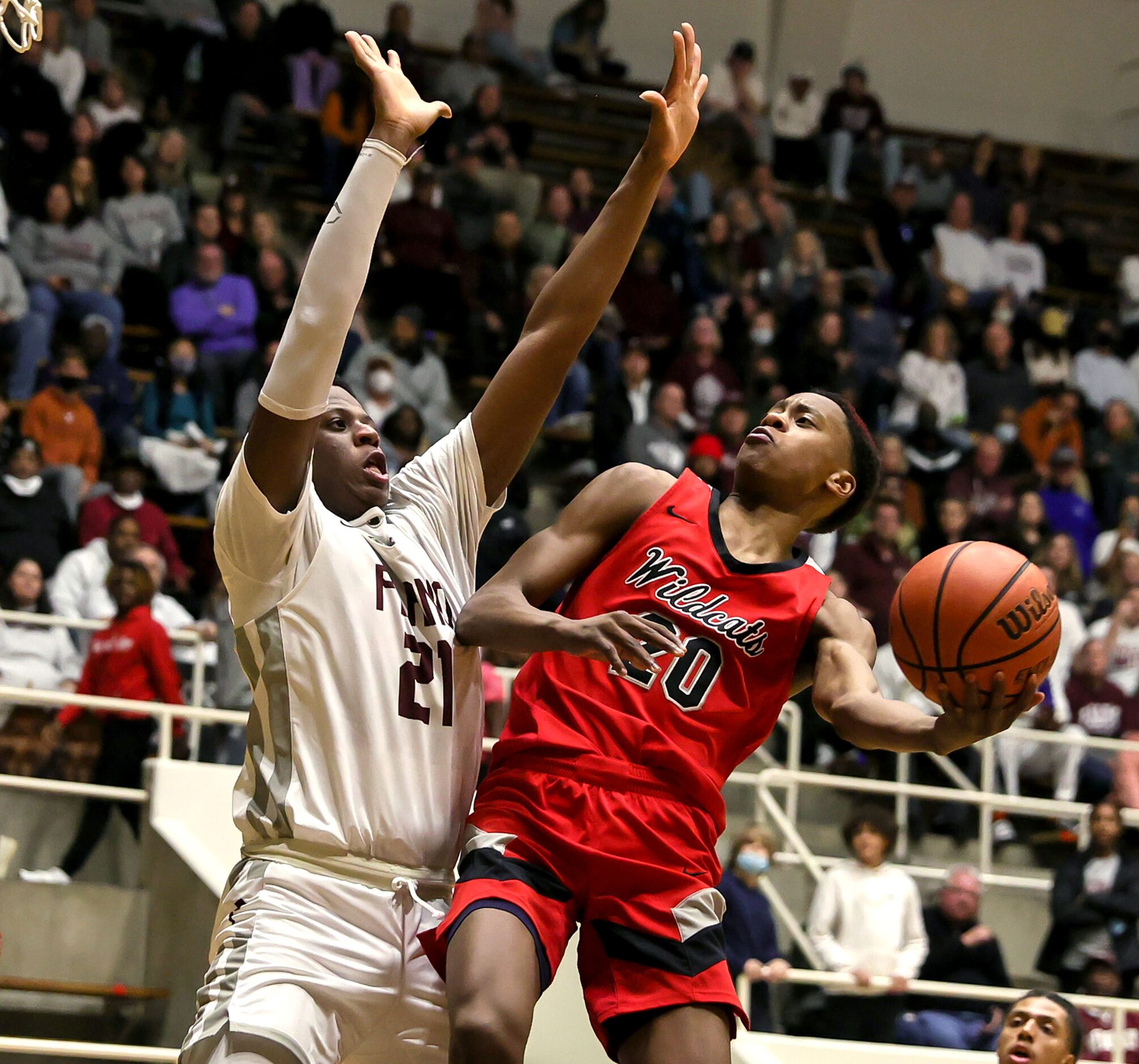 Lake Highlands guard Tre Johnson (20) tries to drive to the basket against Plano forward...