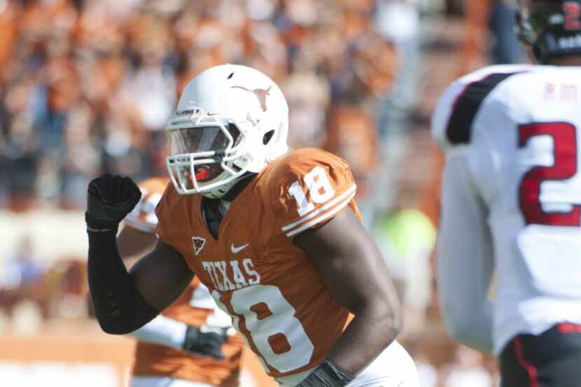 Former Texas linebacker Emmanuel Acho gives a signal during Texas’ 52-20 win over Texas Tech...