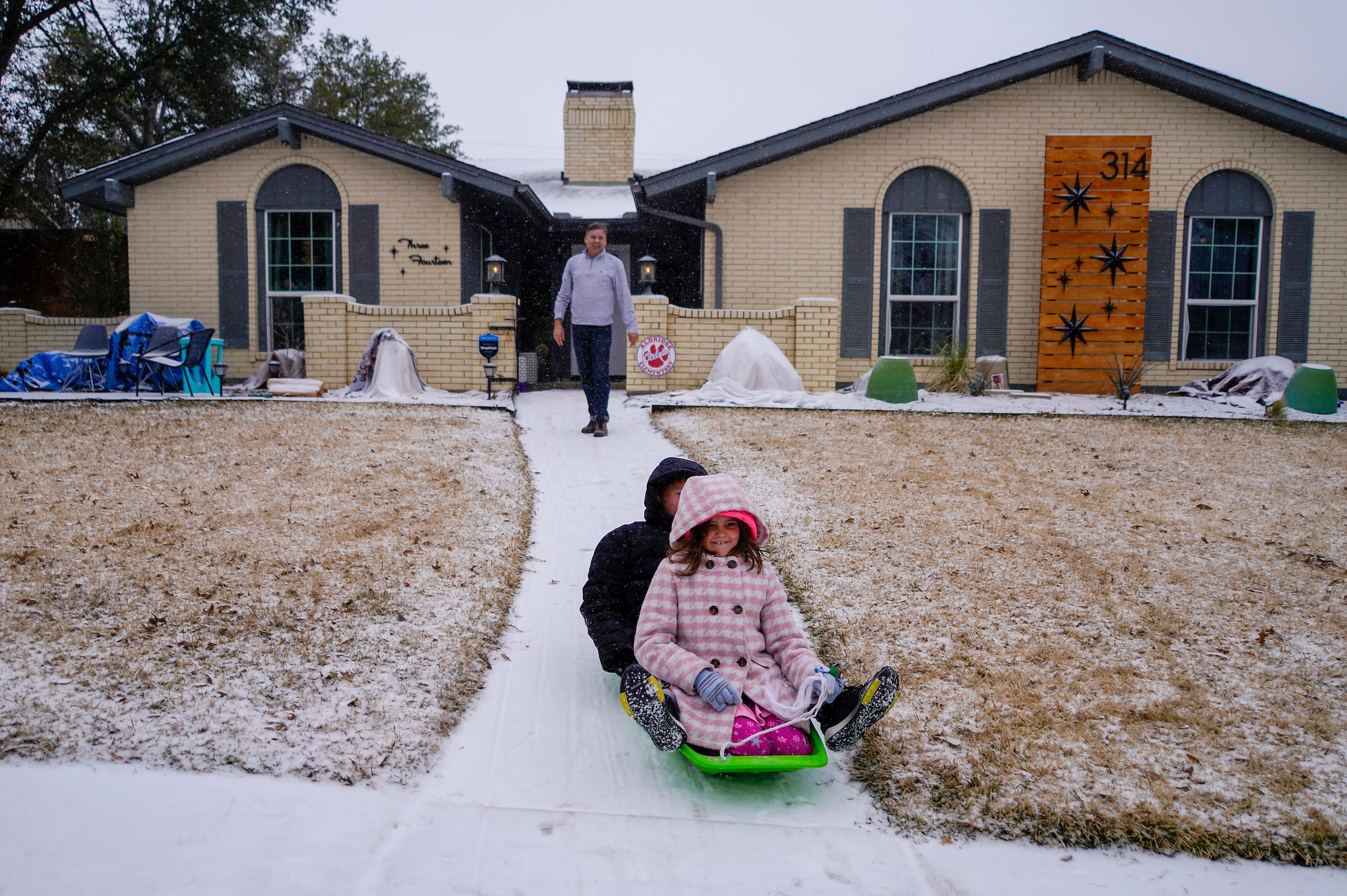 Mae, 9, and Vaughn, 11, Scrogginthorpe get a push from their dad Micah Scrogginthorpe they...