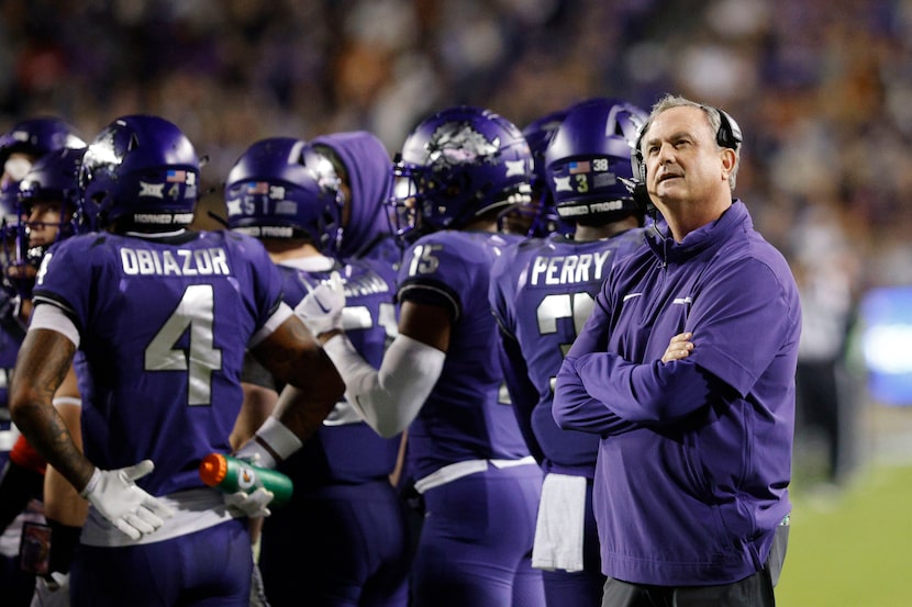 TCU Horned Frogs head coach Sonny Dykes, right, looks up the score board during the first...