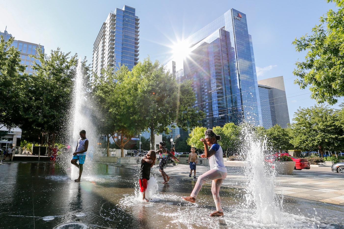 Children enjoy the Moody Plaza water feature at Klyde Warren Park on Wednesday, June 23,...