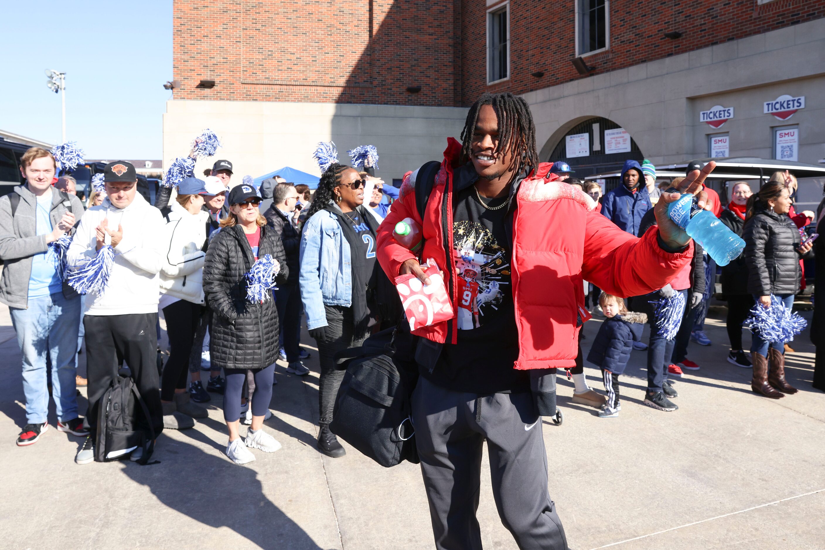 SMU wide receiver Key'Shawn Smith waves towards the crowd as he makes his way out during a...