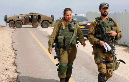 Israeli soldiers block a road in the Israeli-annexed Golan Heights on Feb. 10. Israel struck...