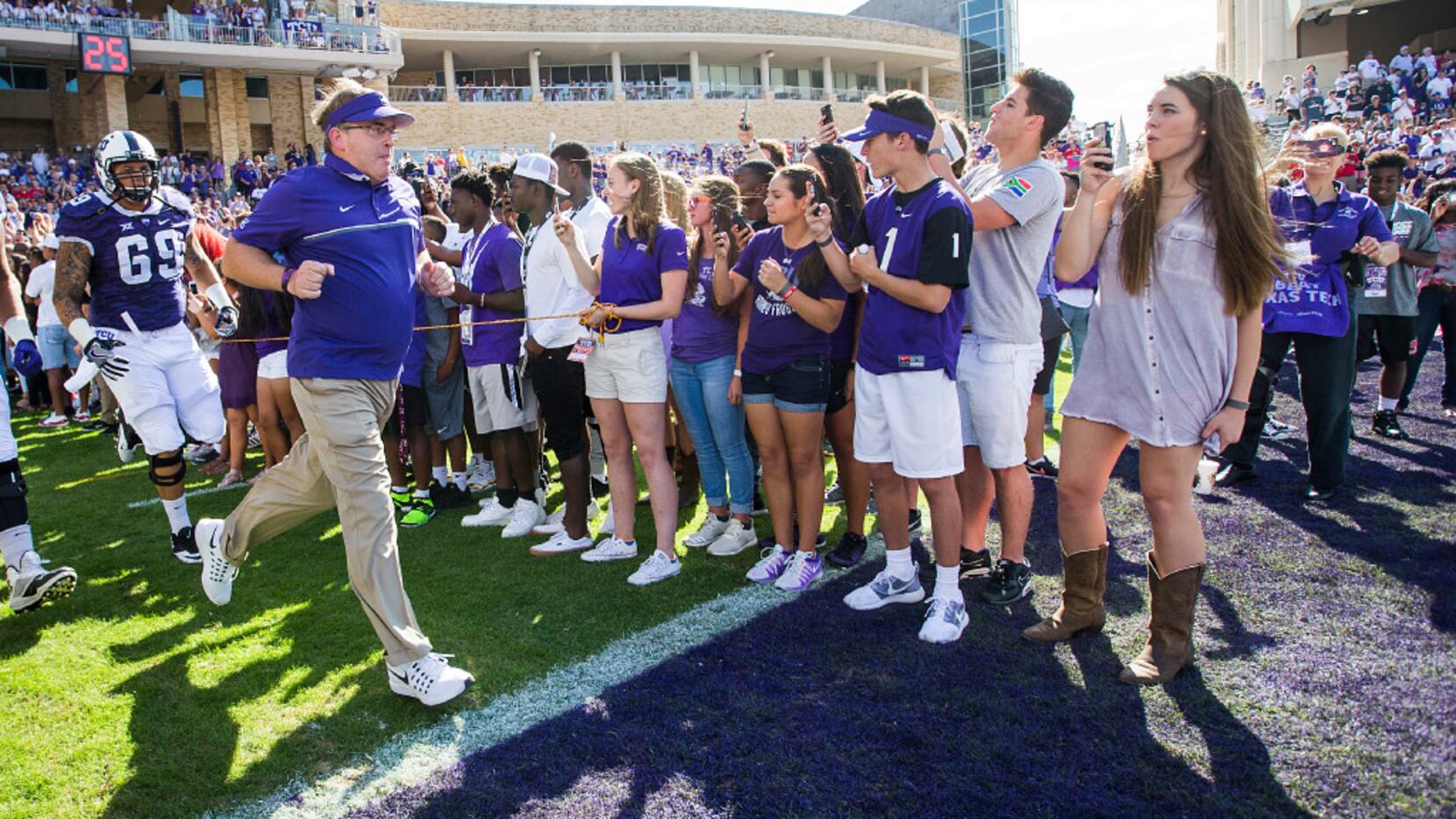 TCU head coach Gary Patterson leads his team onto the field before an NCAA football game...