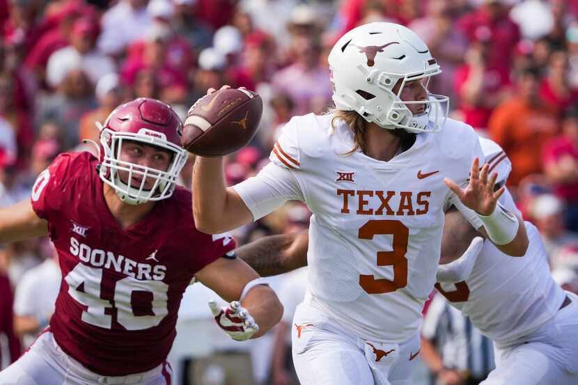 Texas quarterback Quinn Ewers (3) scrambles away from Oklahoma defensive lineman Ethan Downs...