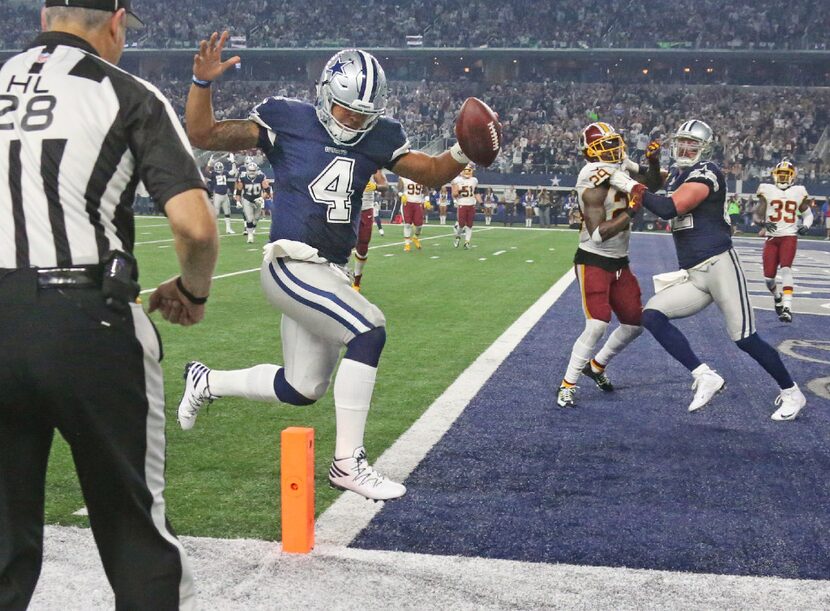 Dallas Cowboys quarterback Dak Prescott (4) scores on a fourth-quarter touchdown run in...