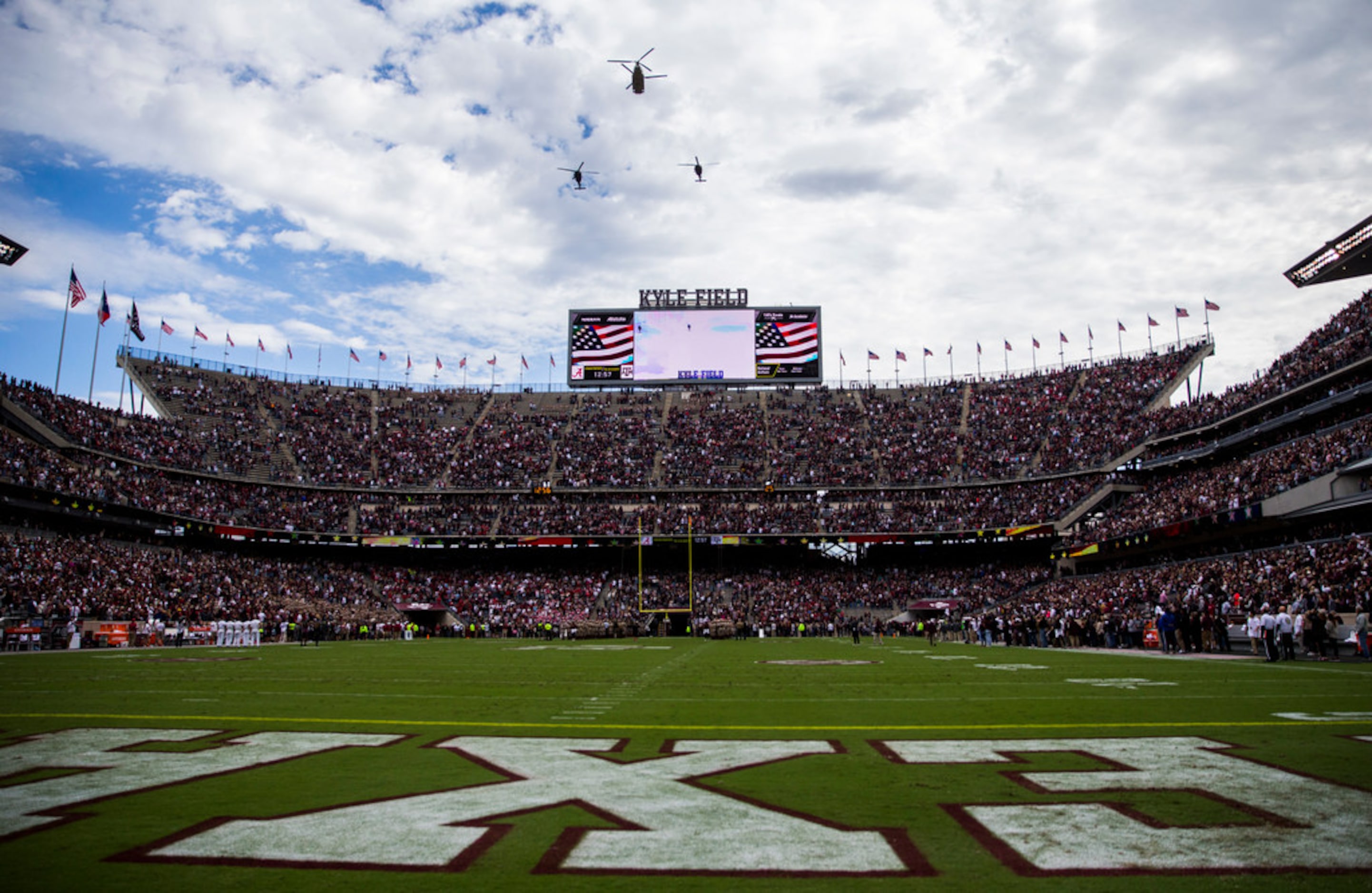 Helicopters fly over Kyle Field before a college football game between Texas A&M and Alabama...