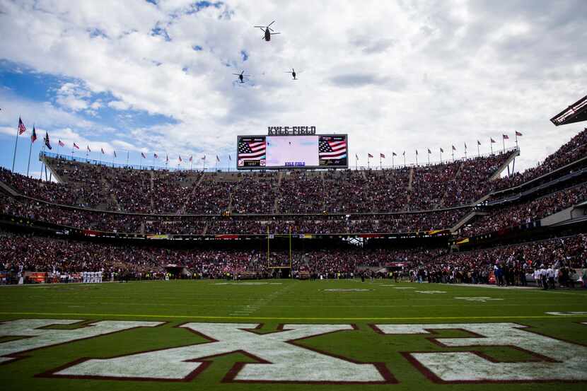 Helicopters fly over Kyle Field before a college football game between Texas A&M and Alabama...