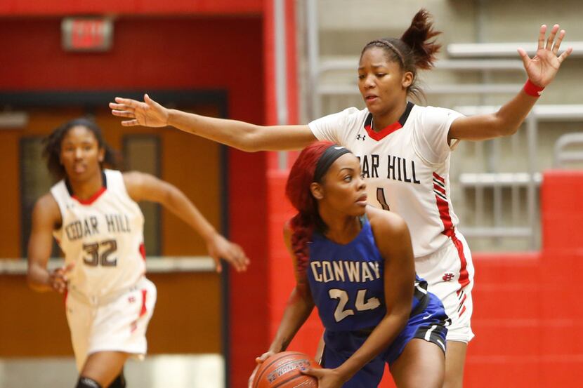 Cedar Hill's Dajinae McCarty (1) is a looming defensive presence for Conway (Ark.) guard...