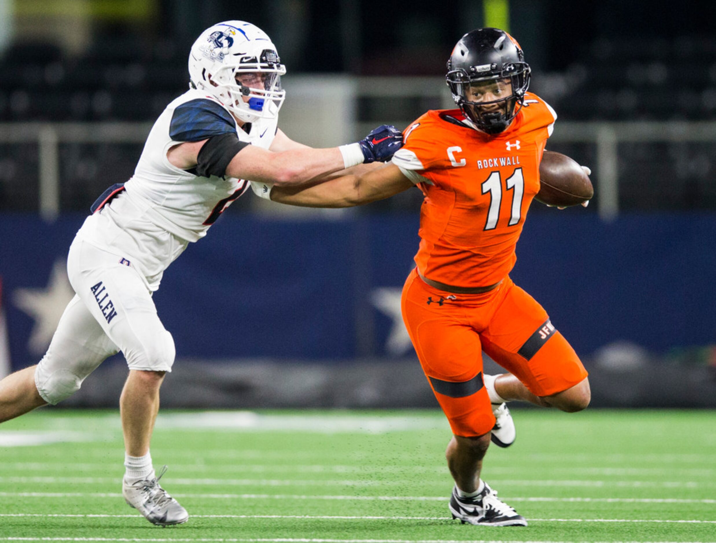 Rockwall wide receiver Jaxon Smith-Njigba (11) pushes away Allen linebacker Jaden Healy (2)...