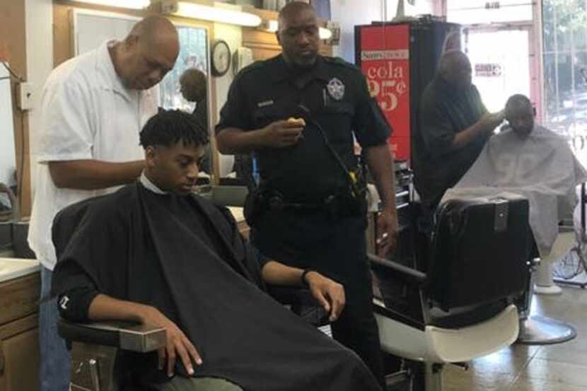 Seventeen-year-old Leighton Douglas gets a haircut during a barbershop talk hosted by Dallas...