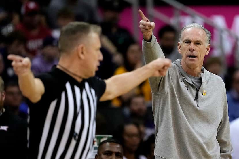 TCU head coach Jamie Dixon motions to an official during the first half of an NCAA college...