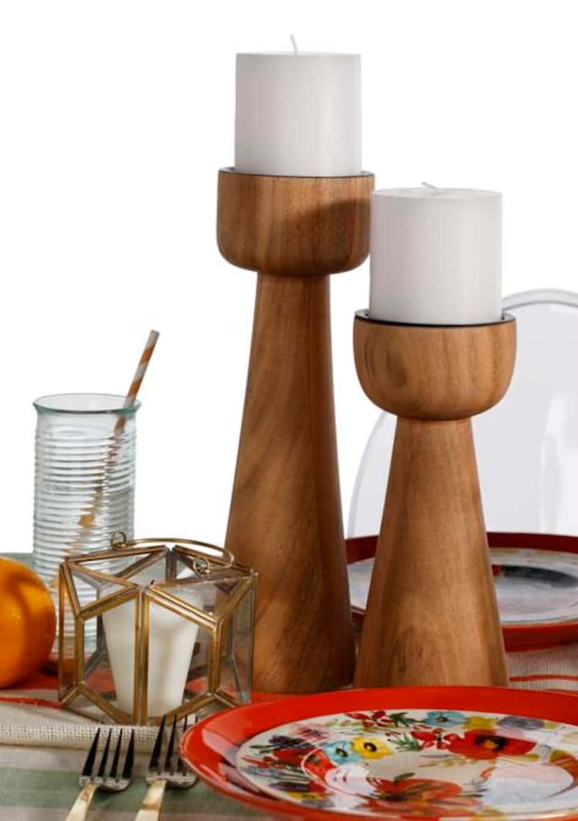 
 Crate & Barrel’s Owen pillar holders are made of acacia wood. $22.95 and $26.95. 
