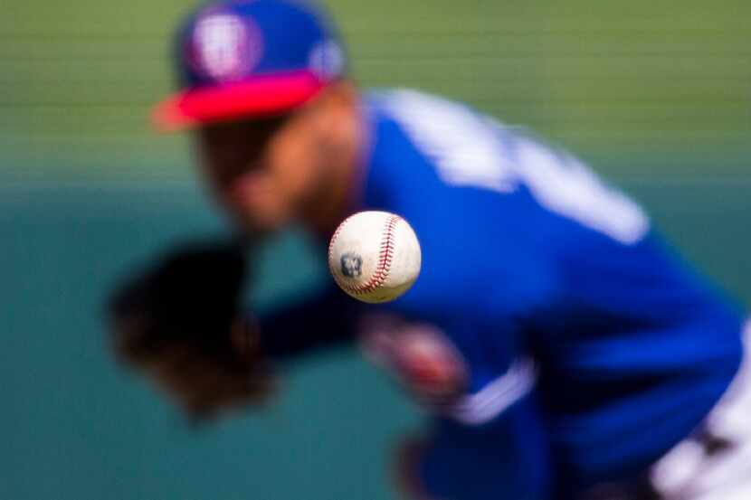 Texas Rangers relief pitcher Yohander Mendez (65) pitches during the third inning of a...