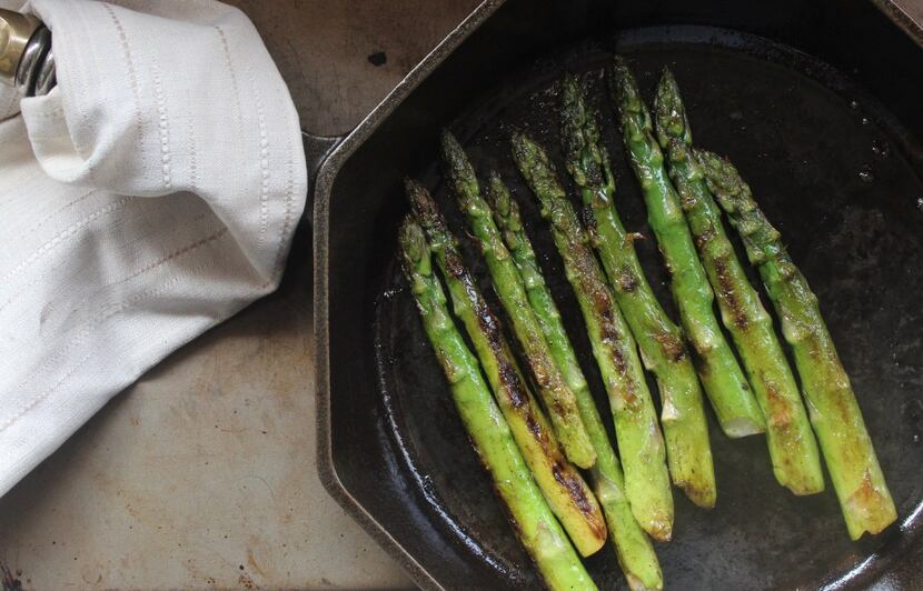 Coat asparagus evenly with butter by gently shaking the pan.