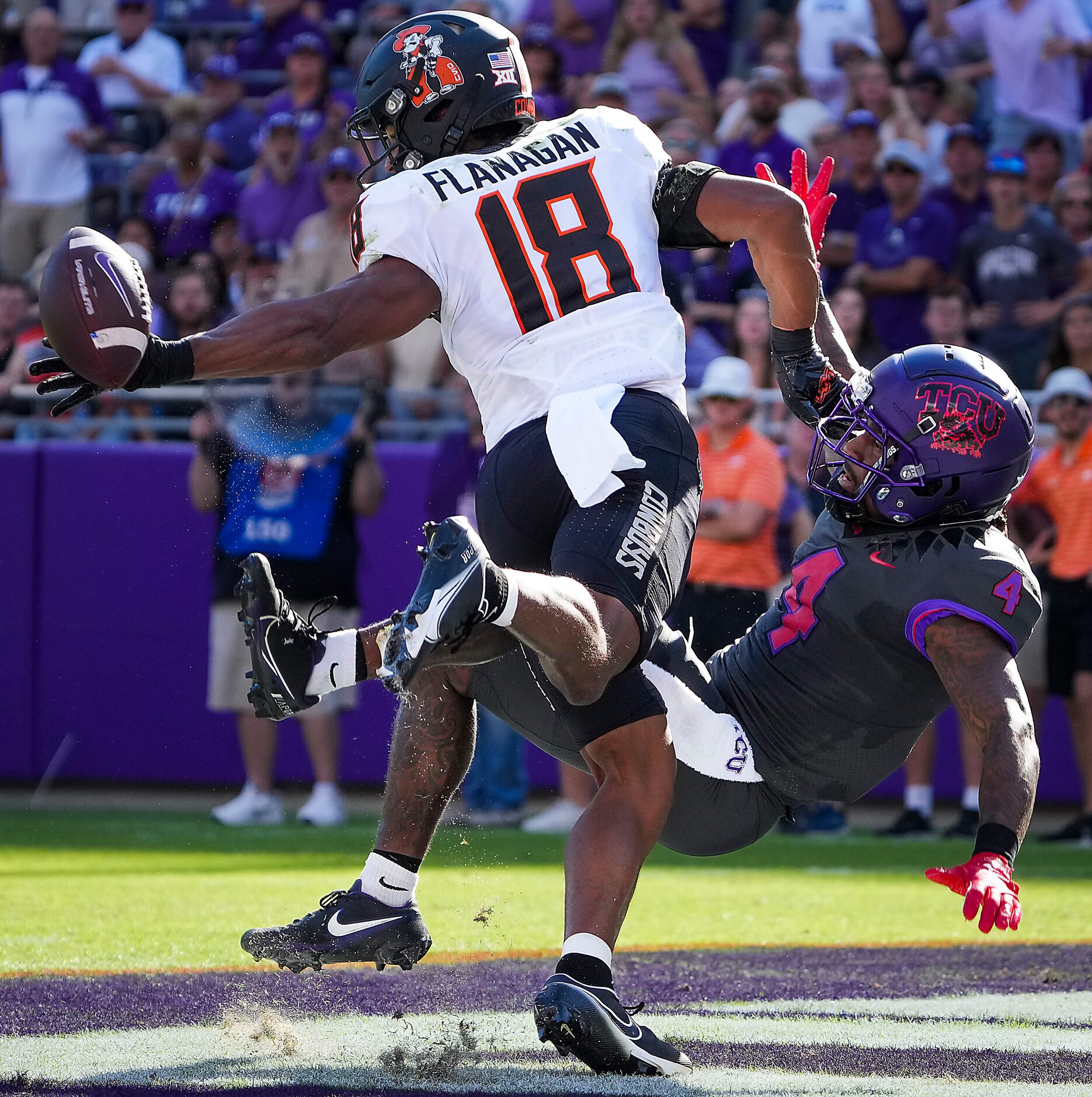 Oklahoma State safety Sean Michael Flanagan (18) breaks up a pass intended for TCU wide...