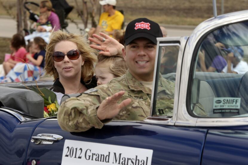 Candice Nelson, Elise Nelson, 3, and Capt. Tim Nelson greeted the crowd in Frisco at a...