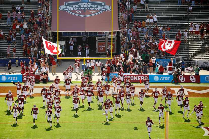 The Oklahoma Sooners football team takes the field to face the Texas Longhorns in the Red...