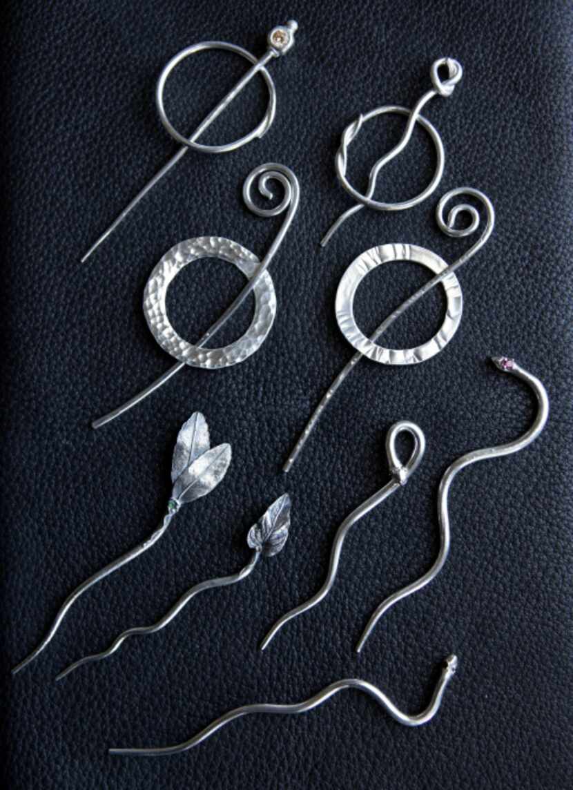 A selection of silver shawl pins and other fired precious metal clay pieces made by Metal...