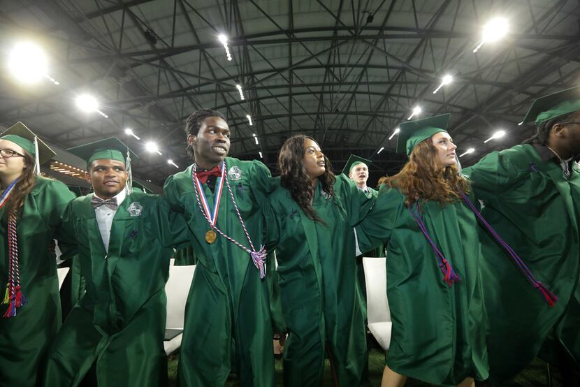Prosper High School seniors participate in their graduation ceremony at The Star in Frisco,...