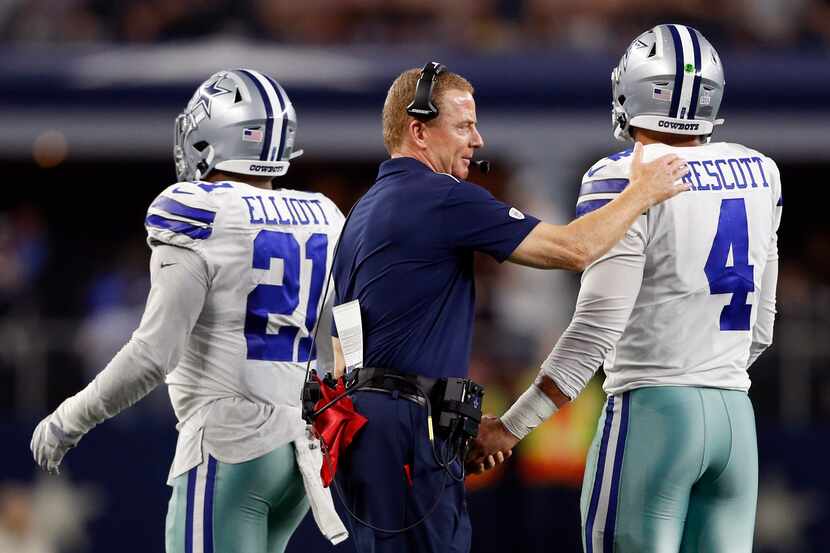 Dallas Cowboys head coach Jason Garrett pats  Dallas Cowboys quarterback Dak Prescott (4) on...