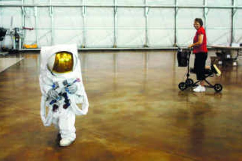  Benjamin Dickson, 6, walked in an astronaut suit while his grandmother Janet Fisher watched...