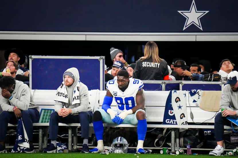 Dallas Cowboys defensive end DeMarcus Lawrence (90) looks on from the bench during the...