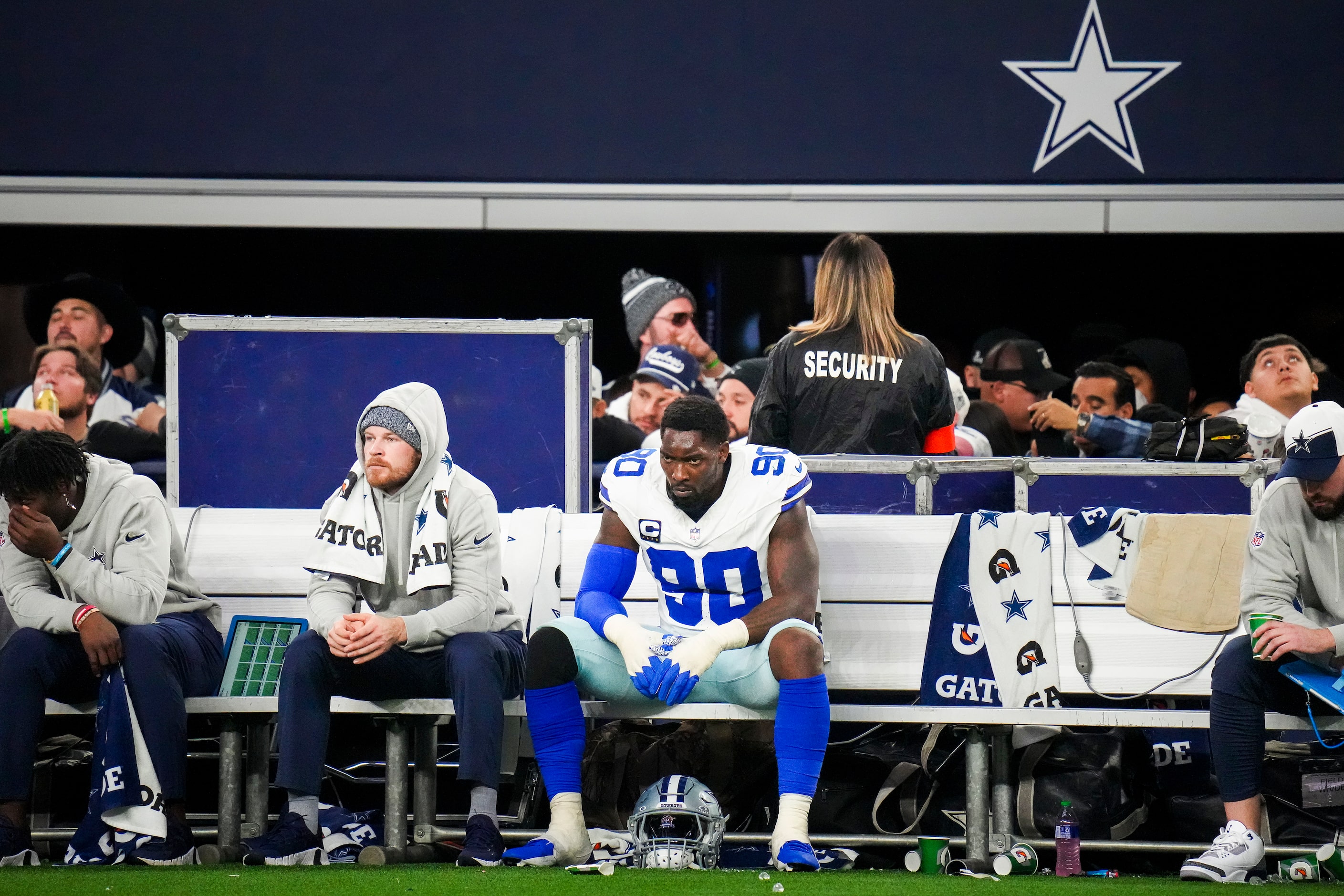 Dallas Cowboys defensive end DeMarcus Lawrence (90) looks on from the bench during the...