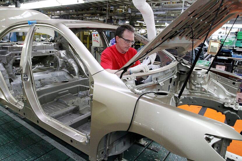 In this file photo, Darryl Ashley installs an inner dash silencer in a Camry on the assembly...