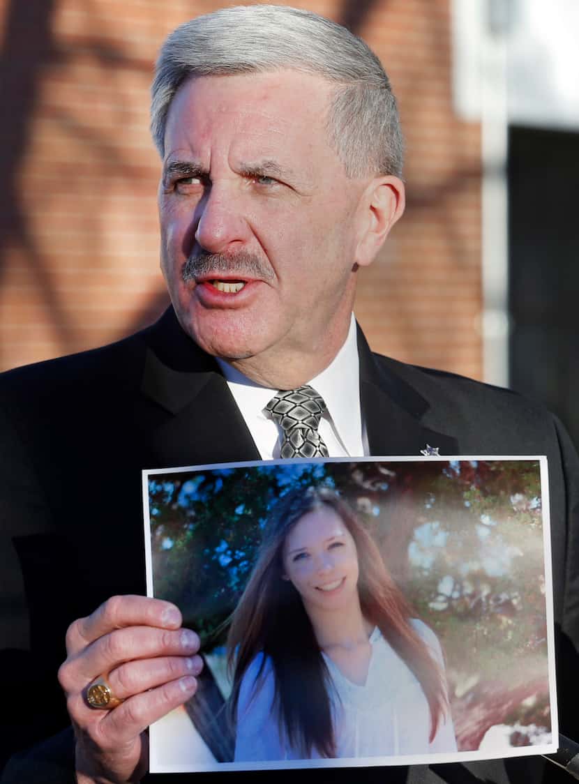 Arapahoe County Sheriff Grayson Robinson holds a picture of Claire Davis the 17-year-old...