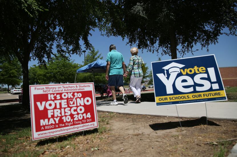 Frisco residents leave the Wester Middle School voting precinct in Frisco, Texas on May 10,...