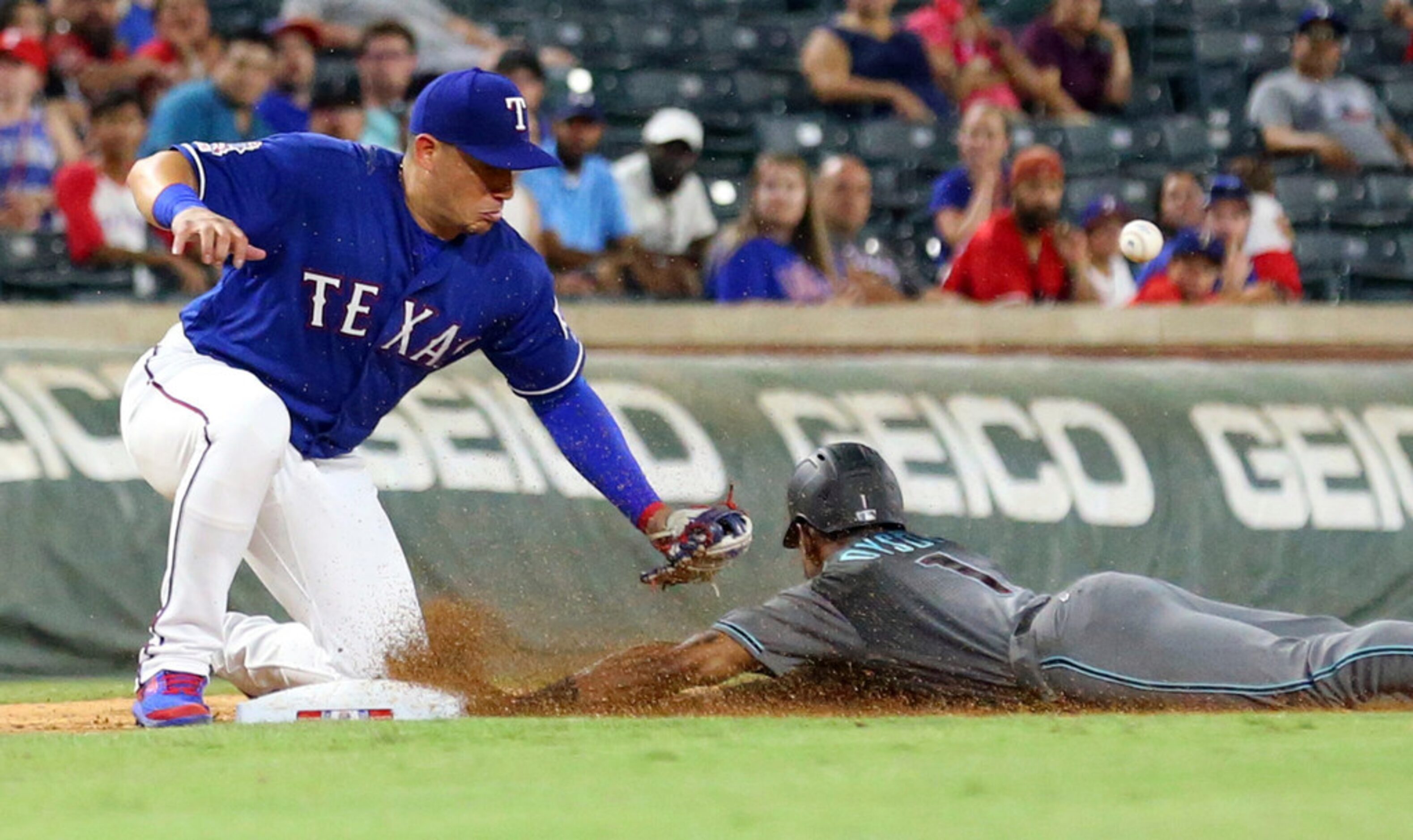 Texas Rangers third baseman Asdrubal Cabrera (14) misses the pickoff throw as Arizona...