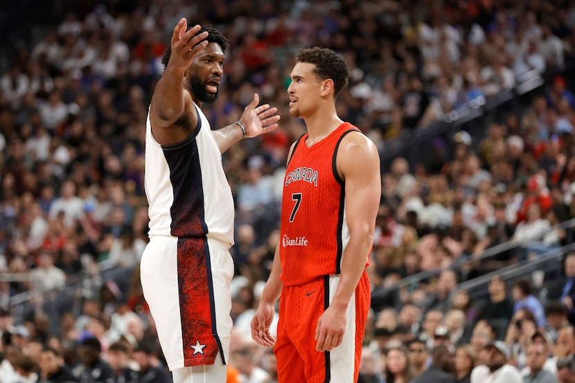 United States center Joel Embiid, left, reacts after fouling Canada power forward Dwight...