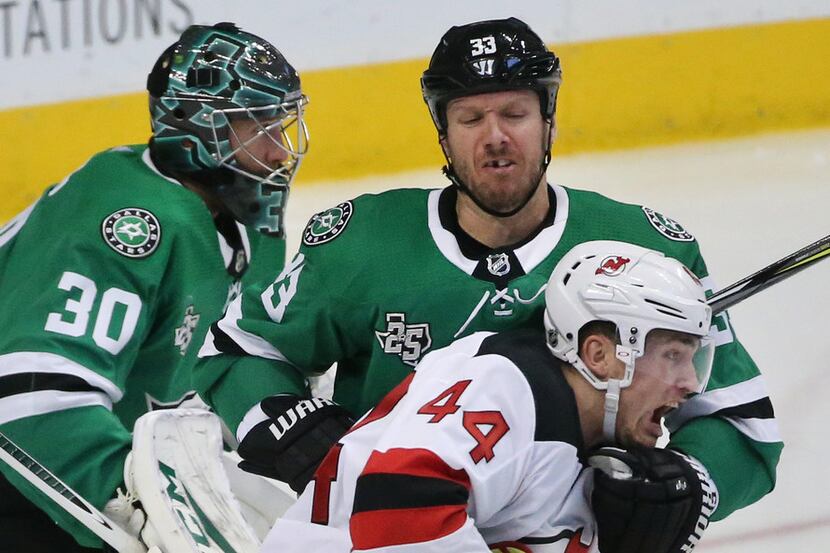 Dallas Stars defenseman Marc Methot (33) tries to move New Jersey Devils left wing Miles...