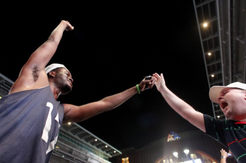 Dallas Mavs fans, Michael Aryee of Dallas, and Rory Cowan of North Ireland high five...