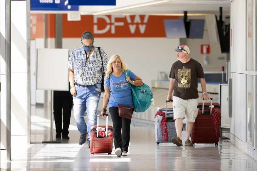 Travelers walk through Terminal B on May 6 at DFW International Airport. 