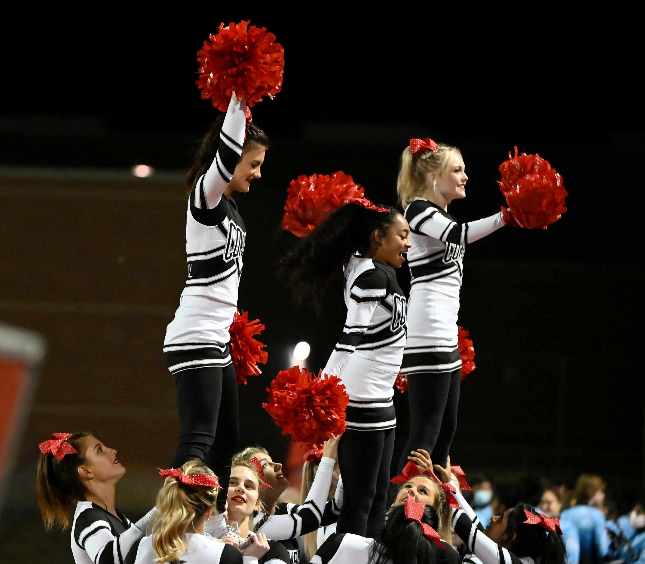 Coppell cheerleaders in the first half of a high school football game between Coppell and...